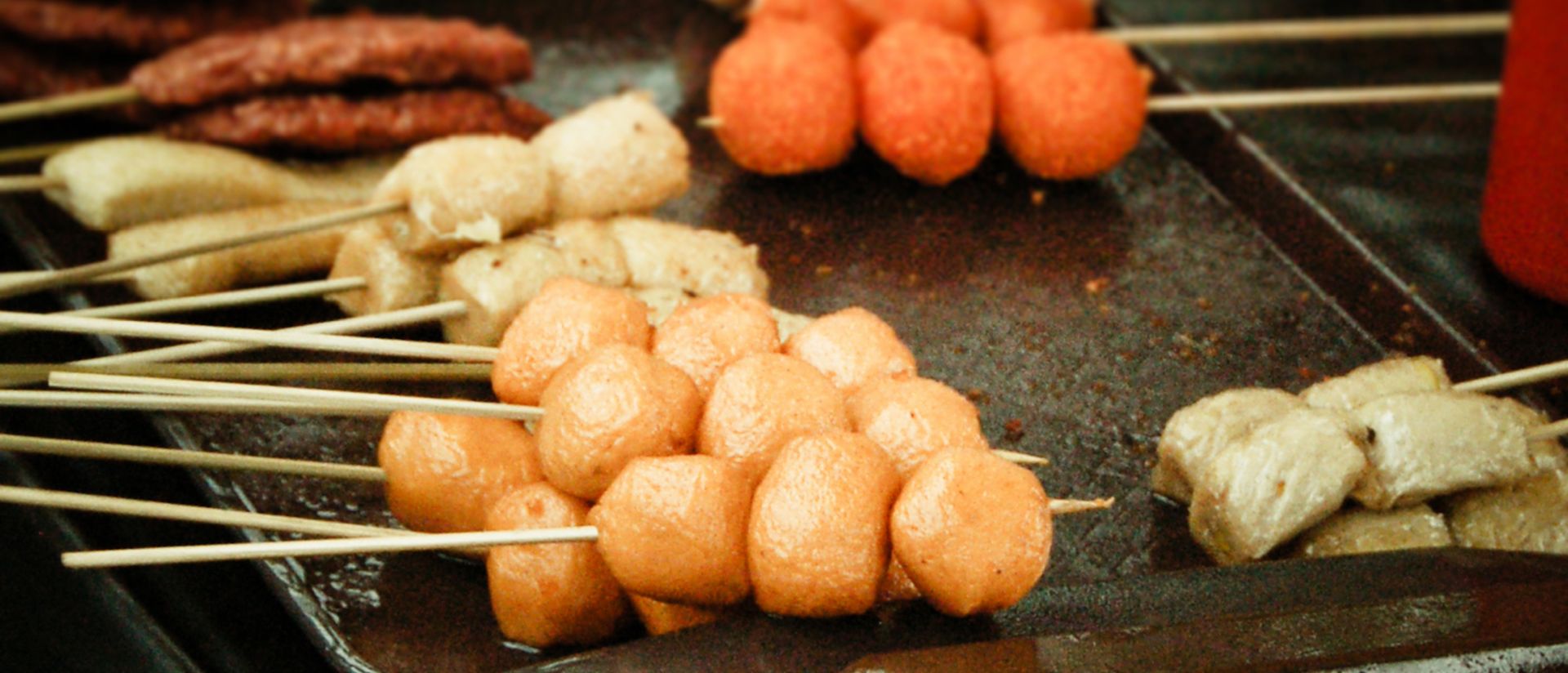 Image of various traditional street food items on a stick