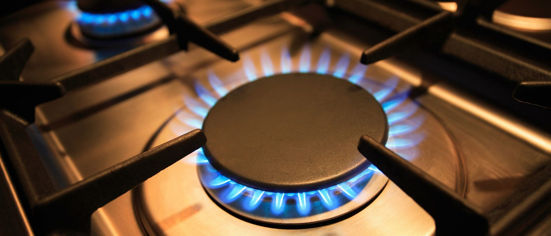 Stovetop gas burner with the flame lit