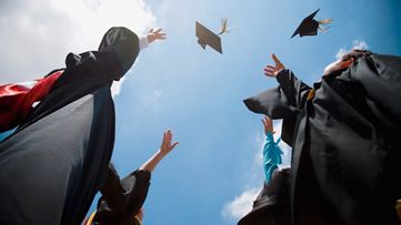  Graduates throwing mortarboards
