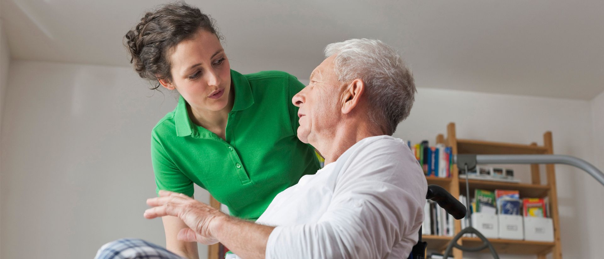 Man in wheelchair speaking with a woman