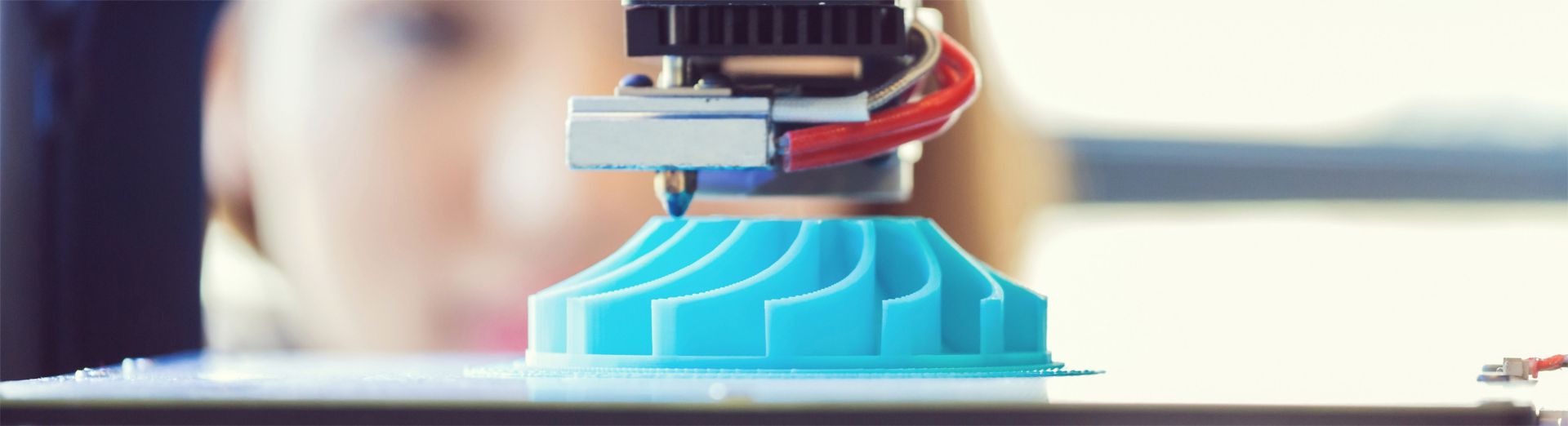 A young woman uses 3D printing technology