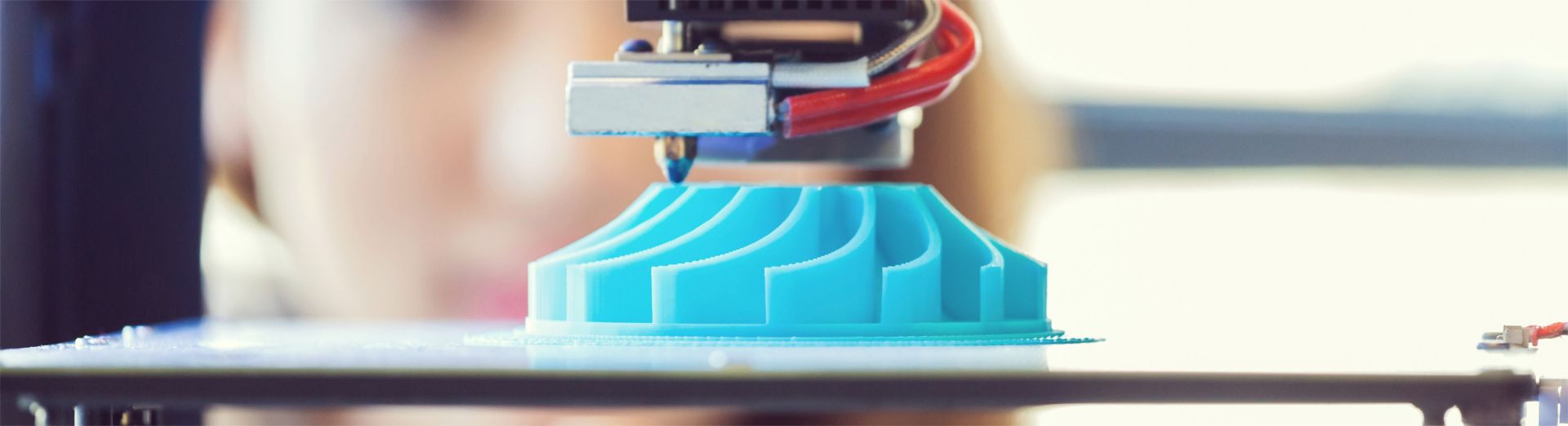 A young woman uses 3D printing technology