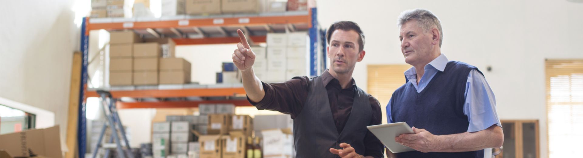 Image of two managers assessing supplies in a coffee stockroom