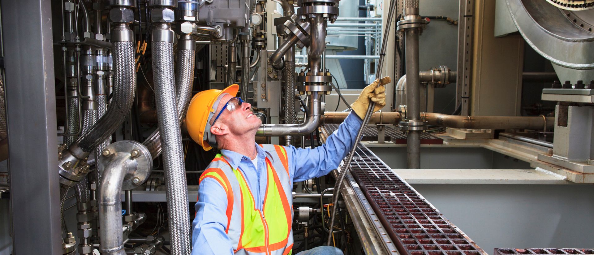 A maintenance technician working in a factory