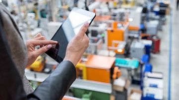 Female manager working on tablet in factory