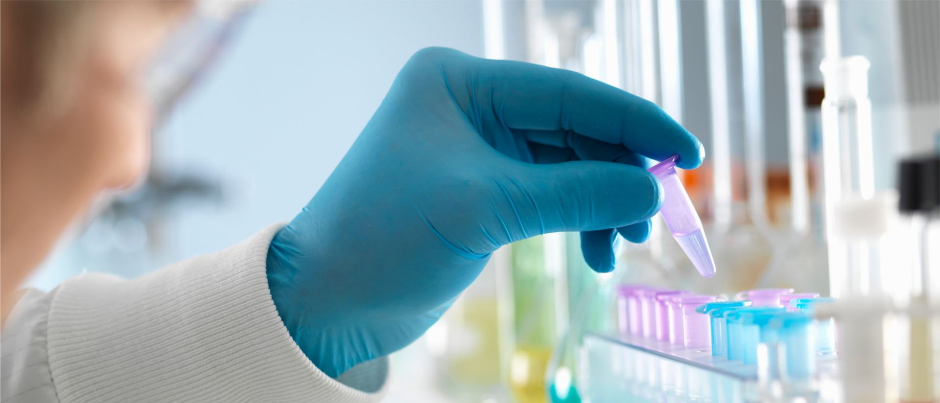 Фотография пипеток с синим химическим веществом, используемым компанией медико-биологической отрасли