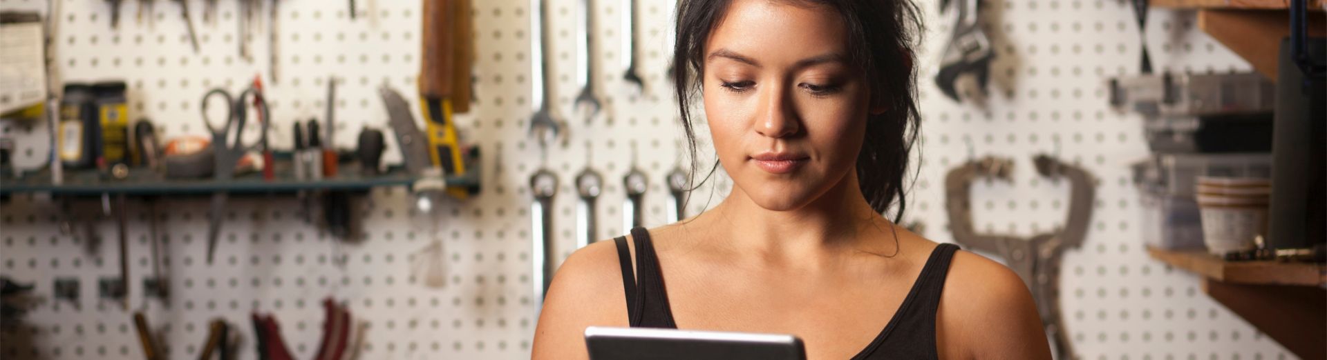 Female mechanic in a workshop using a digital tablet