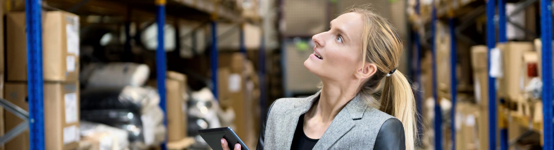 Woman checking inventory with tablet in warehouse