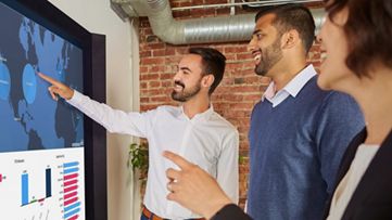 coworkers having a discussion on a big monitor