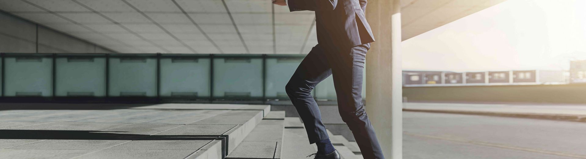 Man wearing a suit runs up the stairs 