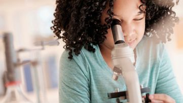 a child looking through a magnifying glass