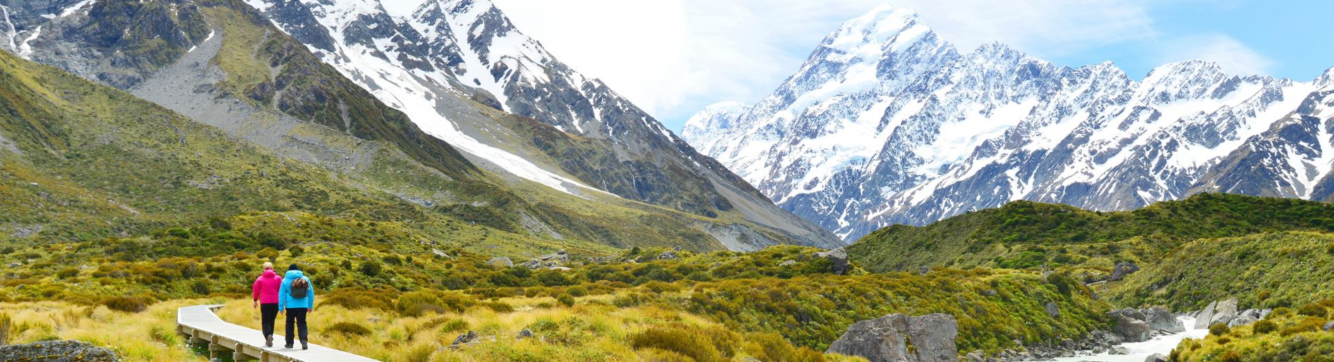 Two hikers walking along mountain range