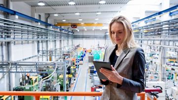 Inspector working in an industrial production warehouse