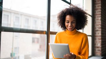 Smiling woman using laptop