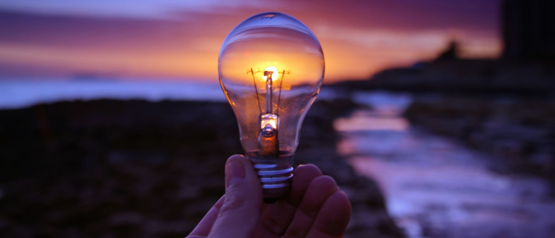 A lightbulb held during sunrise
