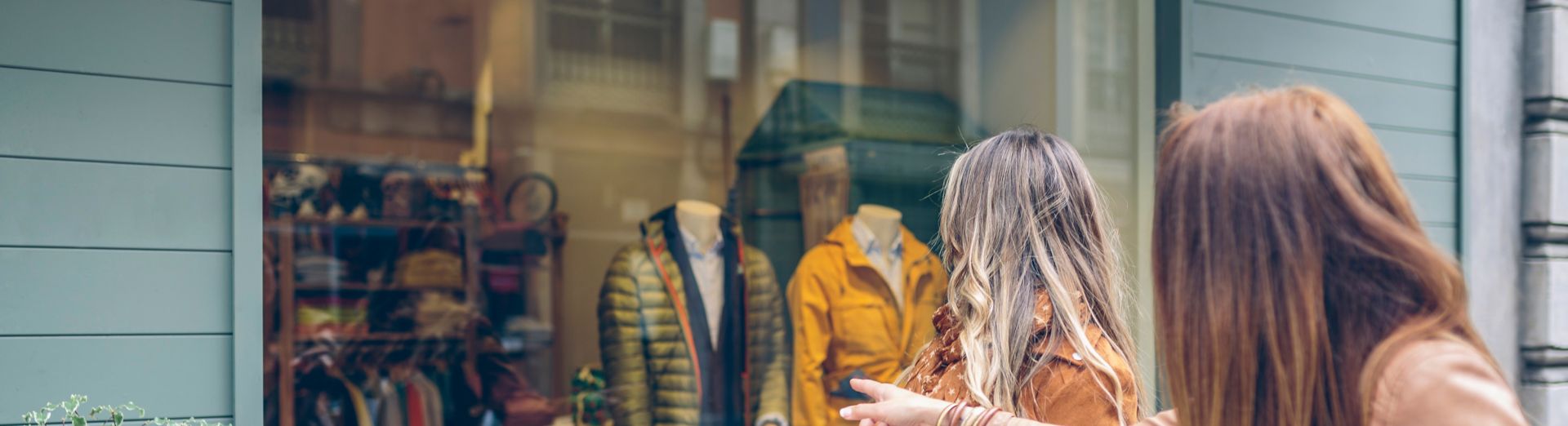 Two women window shopping for fashion