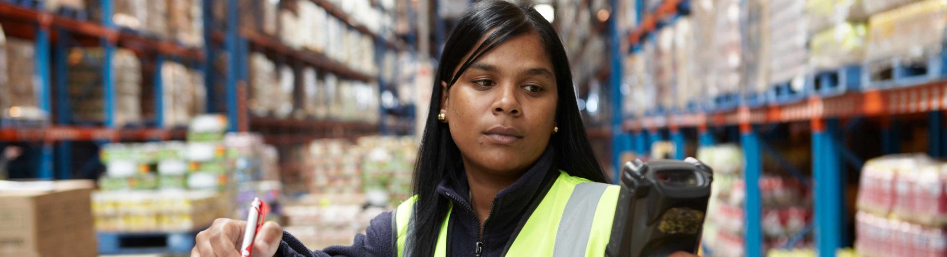 Woman checking inventory in a wholesale distribution center