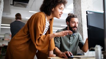 Group of business people collaborating on project in office