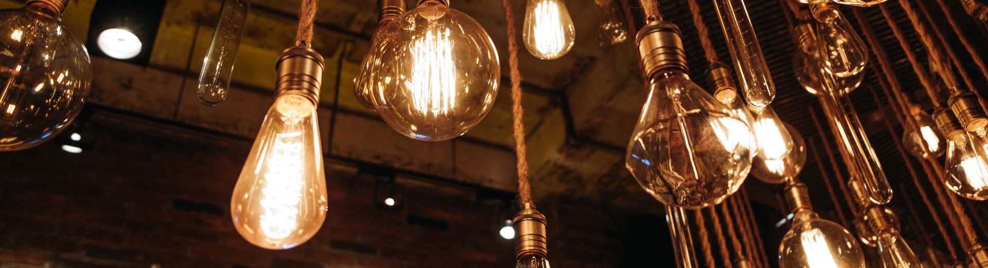 Low Angle View Of Illuminated Light Bulbs Hanging From Ceiling