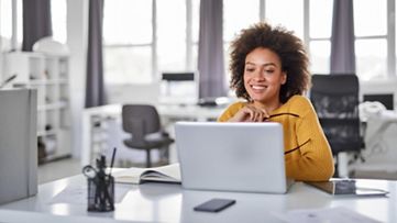 Businesswoman using laptop in office