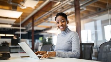 Business manager using a laptop in an office