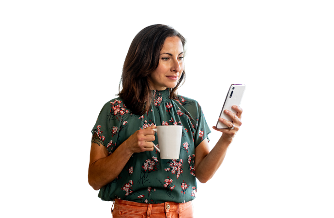 Woman holding coffee using her phone