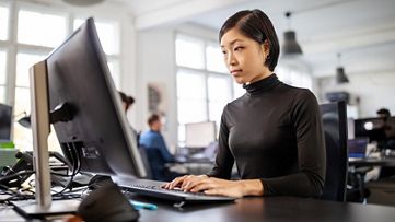 female at computer using SAP Signavio process mining software