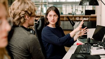 two workers discussing business transformation management