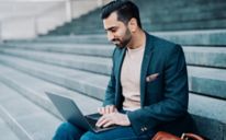 Businessman sitting outside on the building steps
