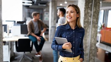 Woman in an office holding a tablet
