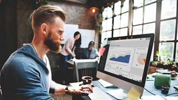 man in the office checking Finance and Economic charts