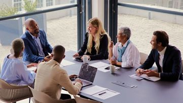 group of coworkers around the table having a discussion