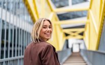  Portrait of happy young businesswoman on a bridge in the city