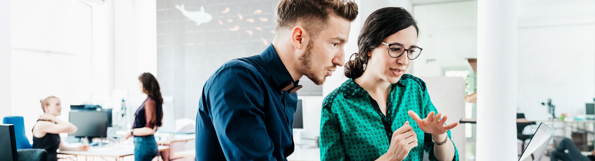 Man and woman on a computer looking at SME business AI software