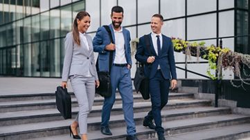 Three people walking down stairs