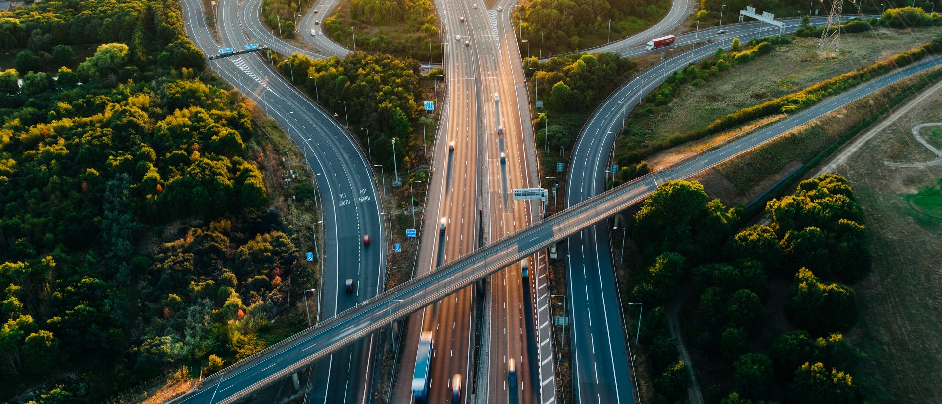 An aerial sunset view of a multi-lane road intersection