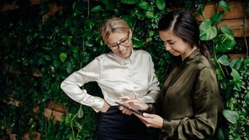 タブレットを一緒に見る 2 人の同僚