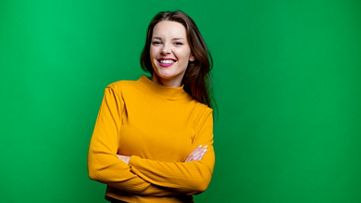 Youn woman standing with crossed arms and smiling