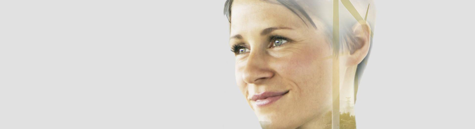 Close-up of a businesswoman with an overlay of greenery on his profile.